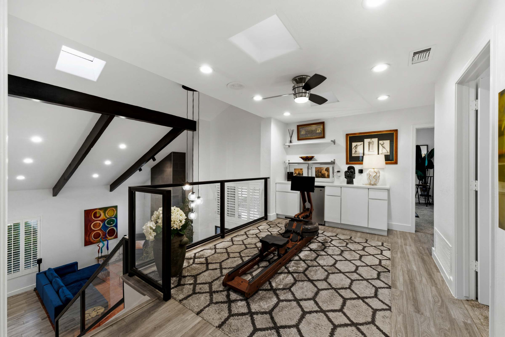 Open loft under beamed ceiling and skylights