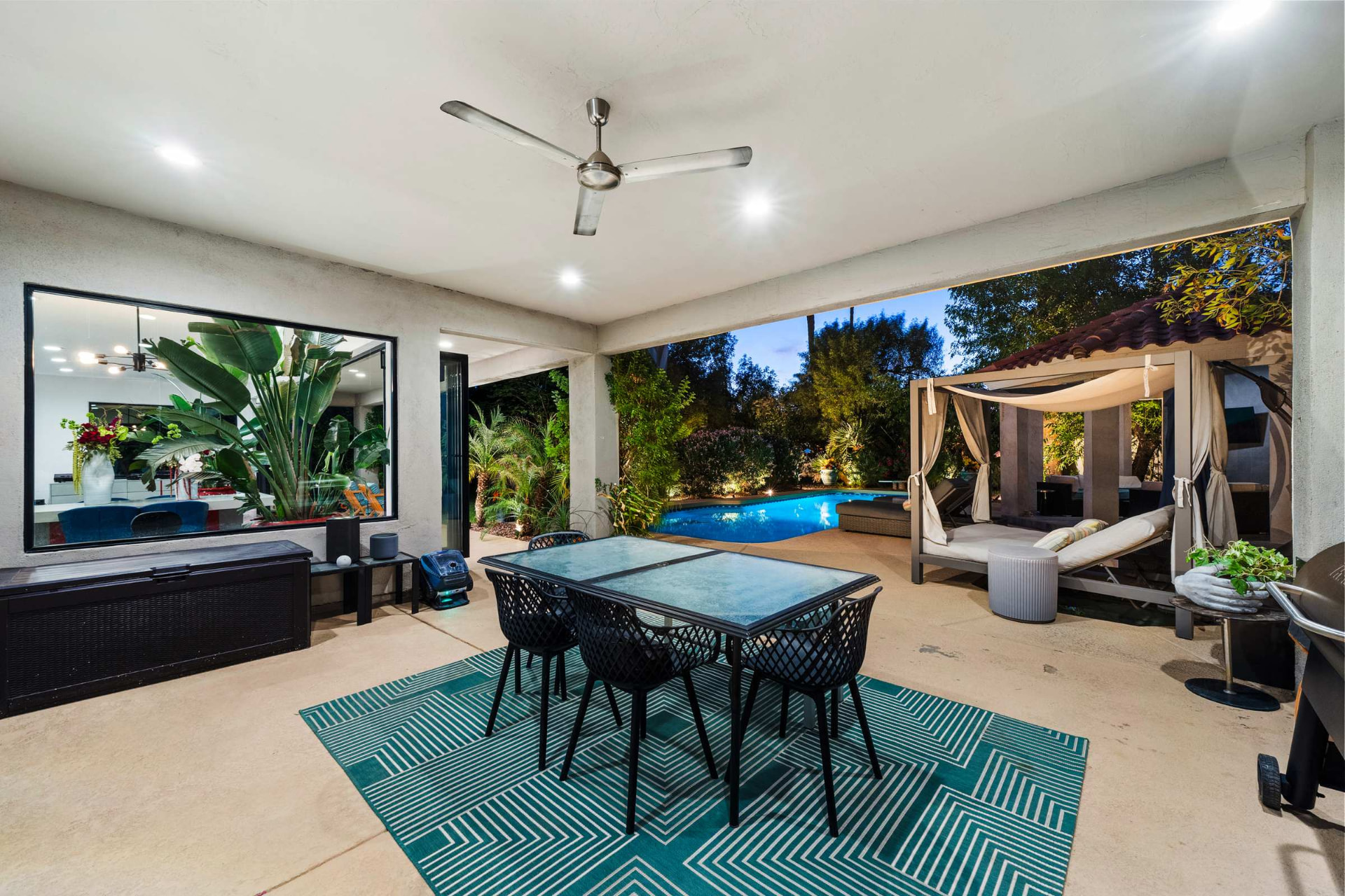 Covered patio dining beside the pool