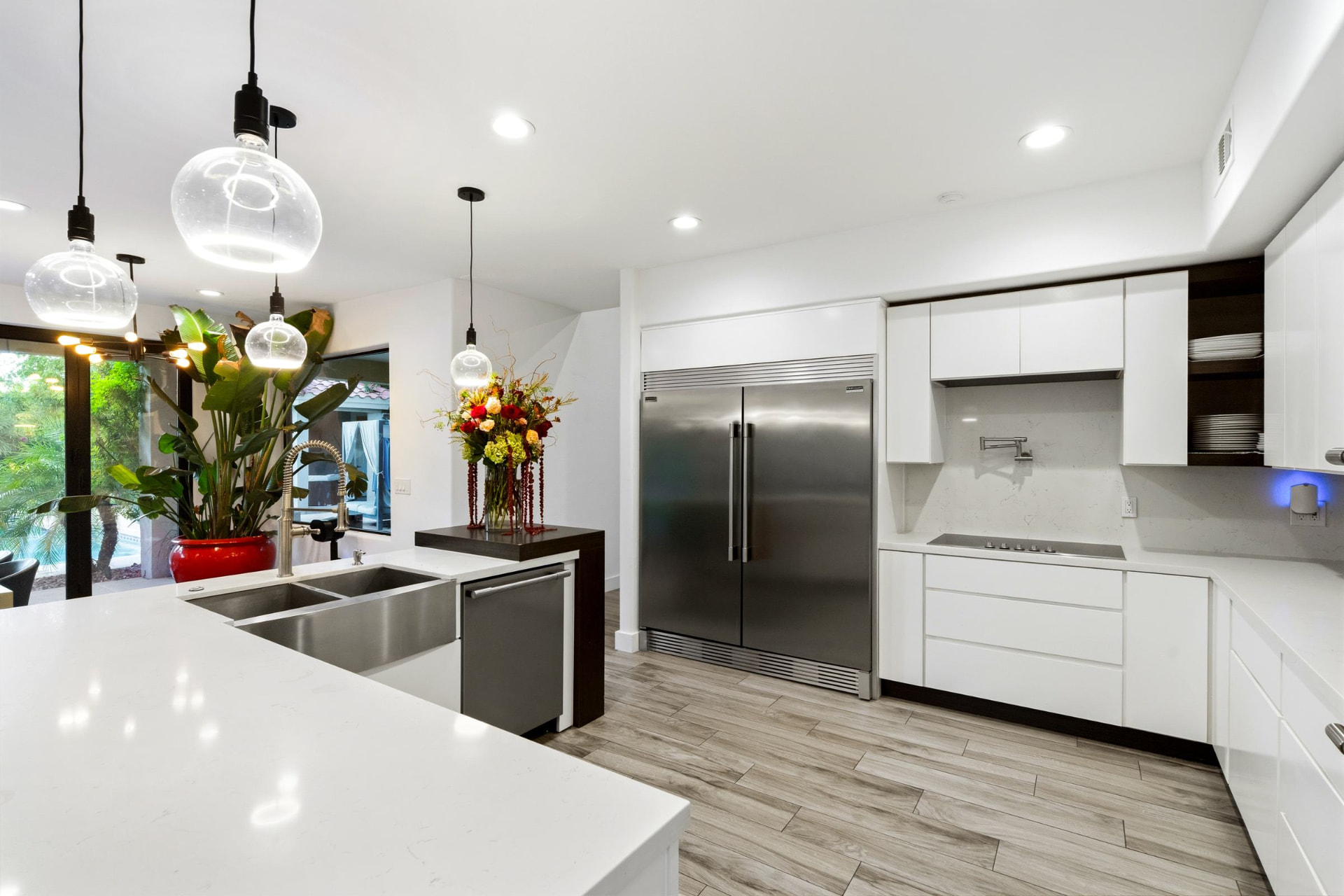 Kitchen with full-size refrigerator and freezer columns and a pot filler