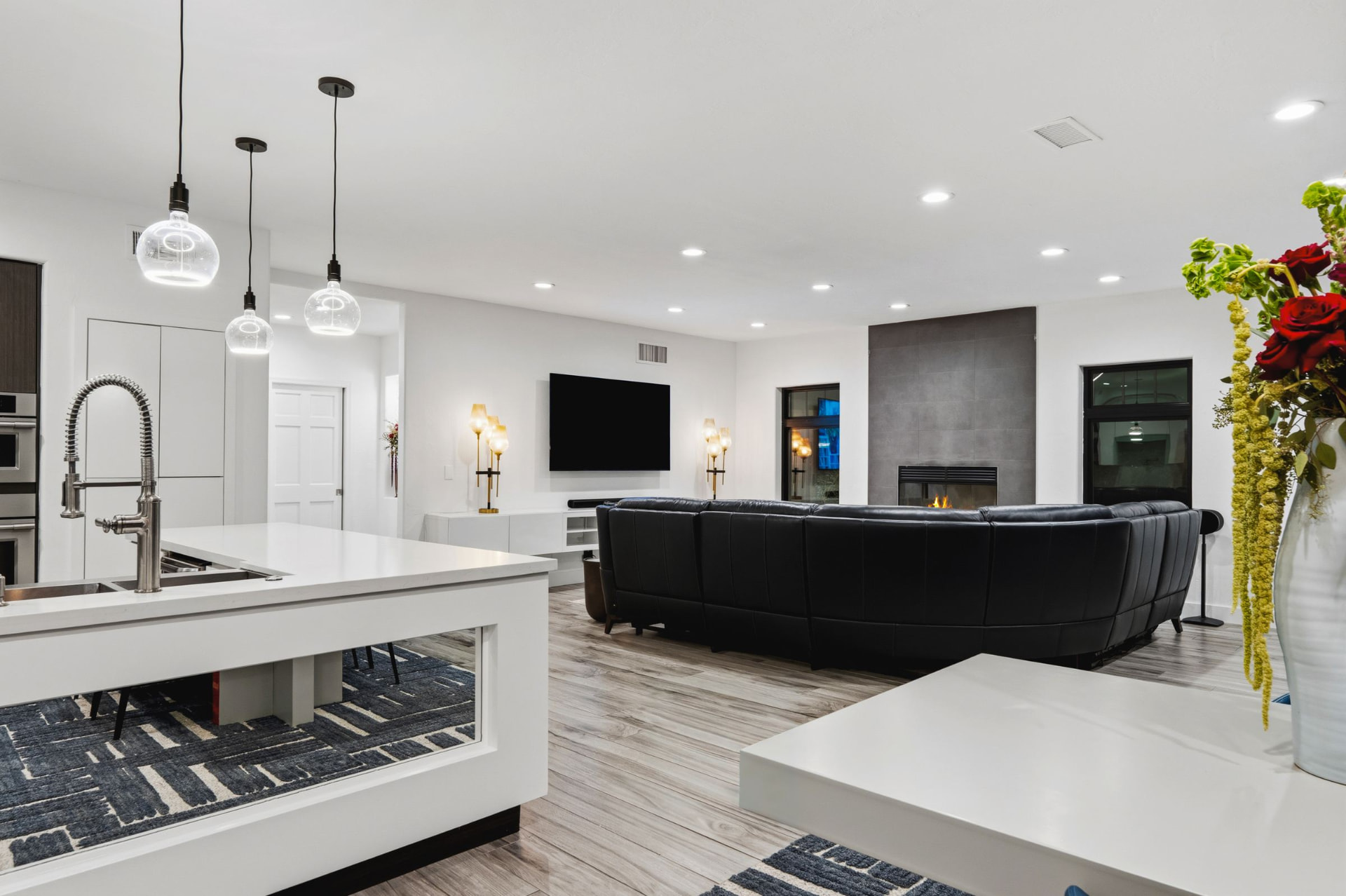 Dining and living space open to the wall of glass