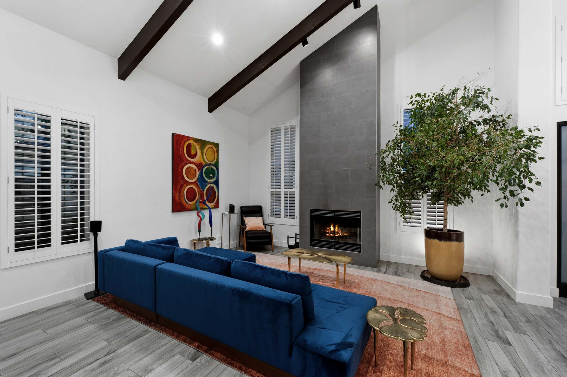 Living room with vaulted ceiling and fireplace